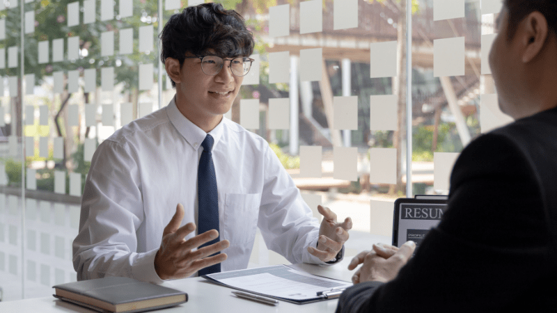 A man speaking to his interviewer at a job interview